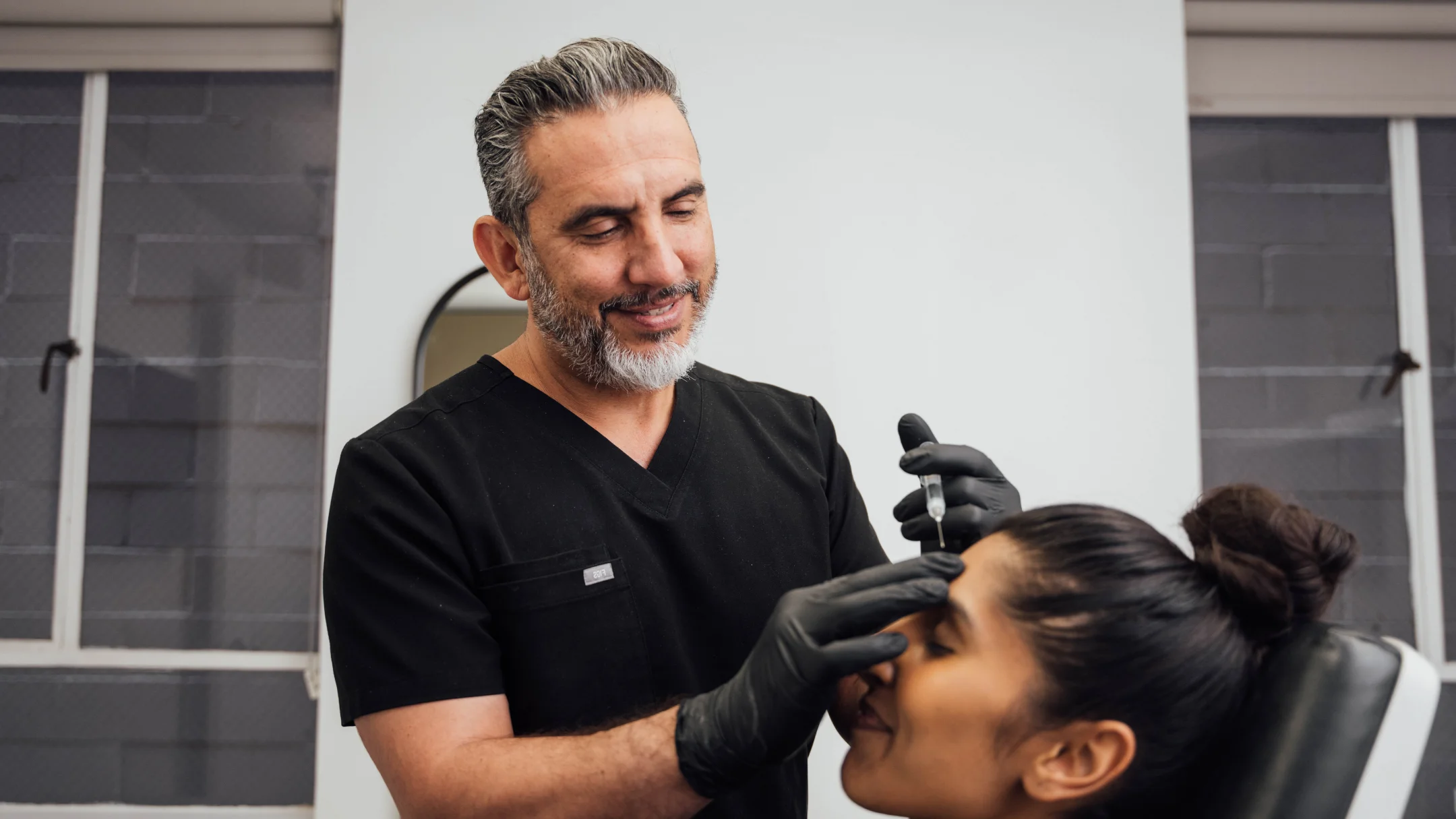 Dr. Sadat administering and injectable treatment